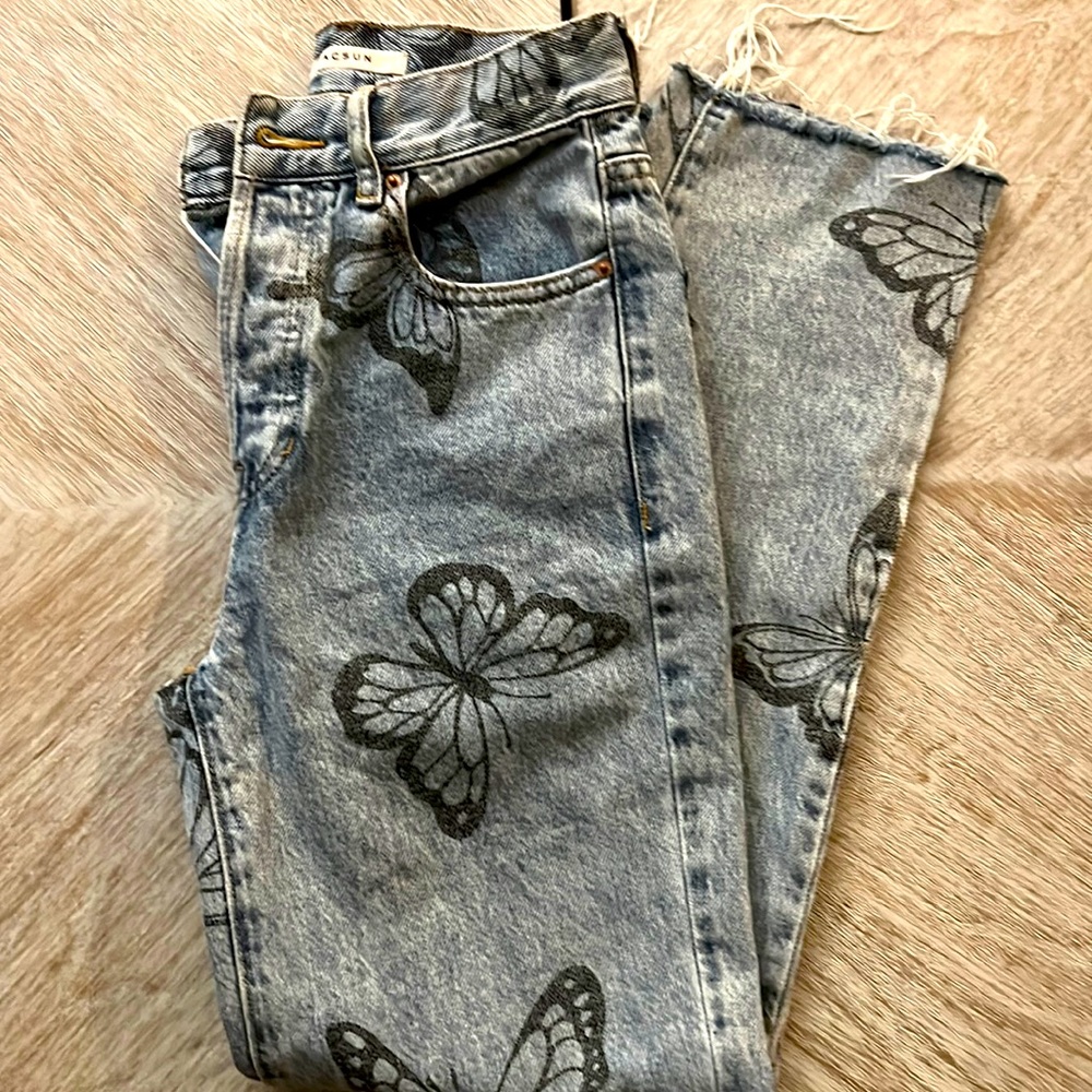 Blue light wash butterfly print jeans.